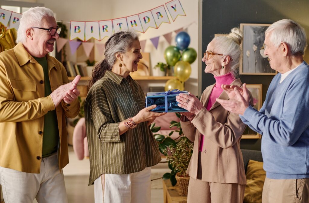 a group of seniors celebrate a birthday part in a senior living community